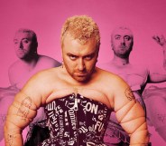 Sam Smith wearing a black corset with white writing on it, against a pink background featuring other images of Smith from their Perfect Magazine photoshoot.