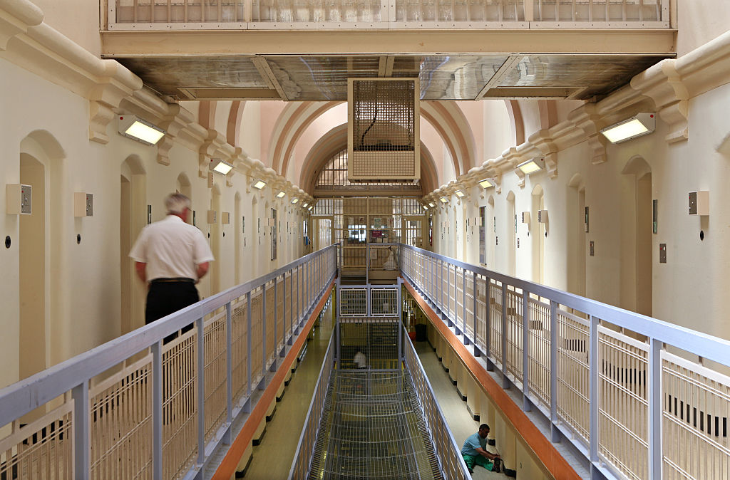 A prison officer walks down the C wing at Wandsworth prison.