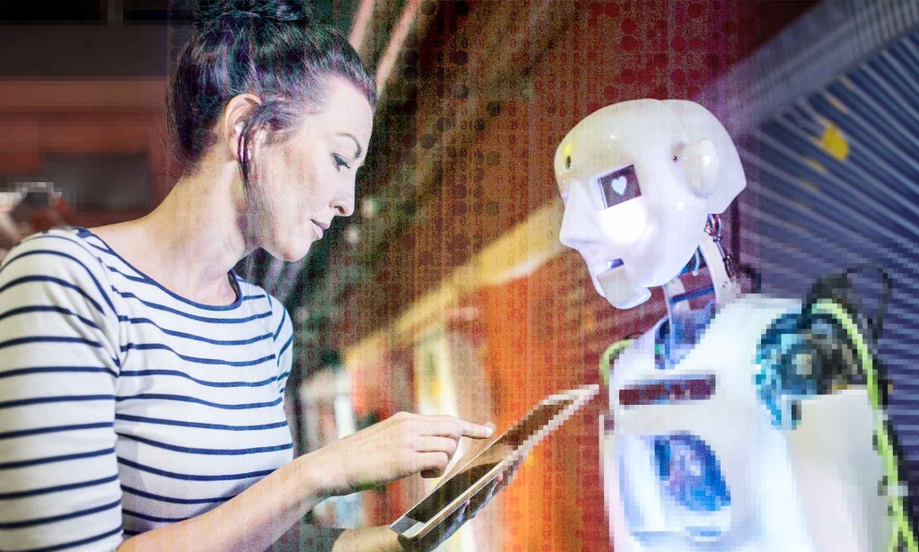 A woman is inputting information into a tablet while standing next to a white robot. 
