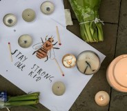 Vigil for victims of Manchester Bombing in May 2017 features drawing of a bee with the words "stay strong our kid"