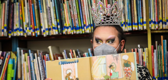 A photo of drag queen Just JP reading stories to children during a Drag Story Hour at Chelsea Public Library in the United States.