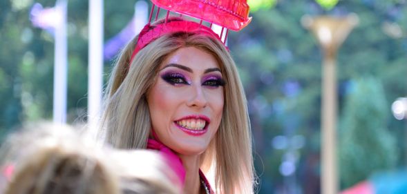 A drag queen smiling during a Pride parade.