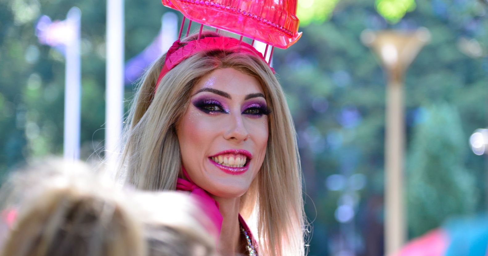 A drag queen smiling during a Pride parade.