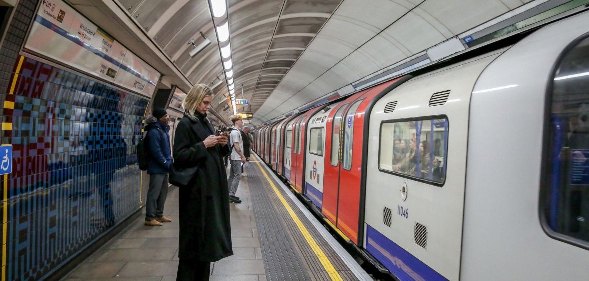 Members of the public wait for a London Underground train.