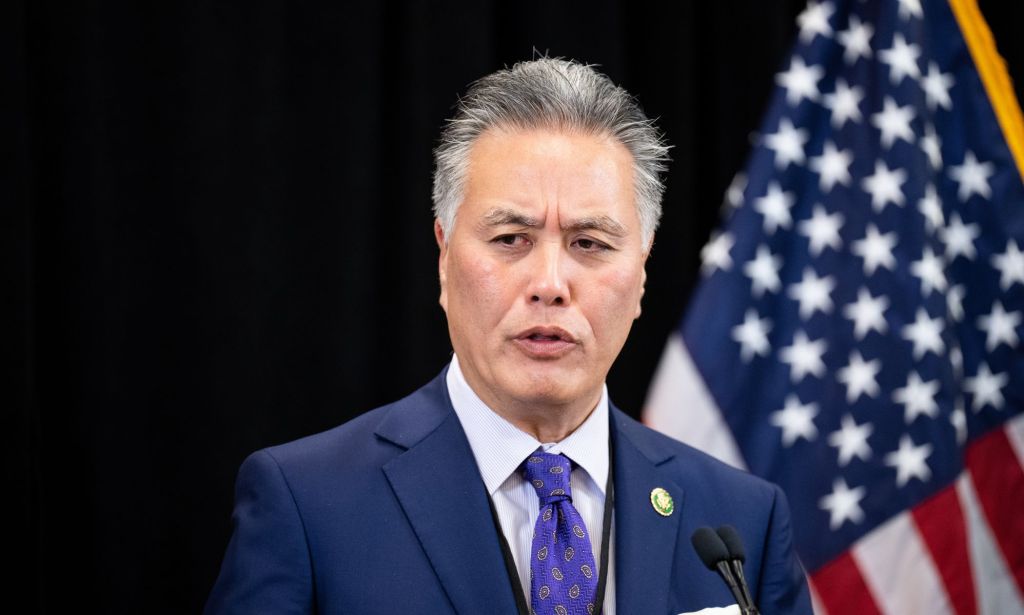 US congressman Mark Takano wears a suit and tie as he speaks to an audience off-screen