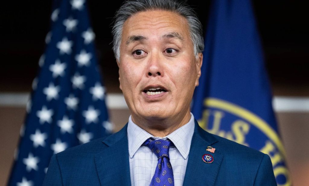 US congressman Mark Takano wears a suit and tie as he speaks to an audience off-screen