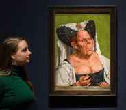 A staff member examine the Ugly Duchess portait.