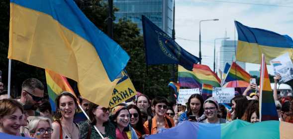 a pride parade in Poland feature the Ukrainian flag