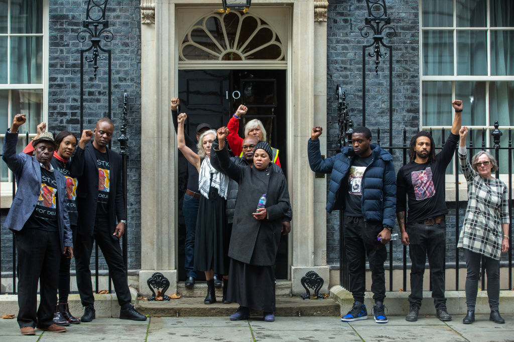 Relatives of Oladeji Omishore, Mark Duggan, Leon Patterson, Matthew Leahy, Chris Kaba, Mouayed Bashir and Jack Susianta raise clenched fists outside 10 Downing Street after presenting letters to the Prime Minister on behalf of the United Families and Friends Campaign (UFFC). 