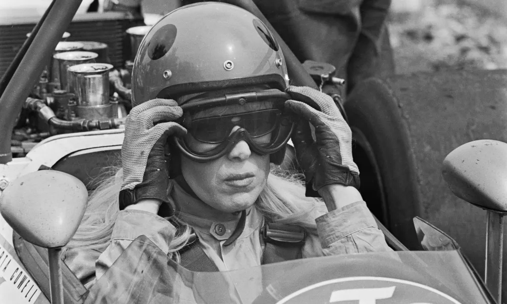 British racing driver and trans woman Roberta Cowell sits in the cockpit of a Kitchmac M10B Formula 5000 racing car during testing in 197