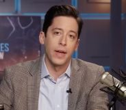 Daily Wire host Michael Knowles wears a button up shirt and jacket as he talks to his podcast/show audience about his anti-trans Conservative Political Action Conference (CPAC) speech