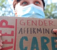 A person holds up a sign reading 'Keep gender-affirming care' during a demonstration in support of healthcare for trans youth