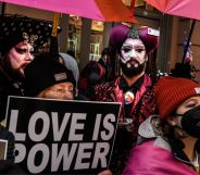 A person holds up a sign reading "Love is power" at a protest attended by LGBTQ+ people and allies in support of Drag Story Hour