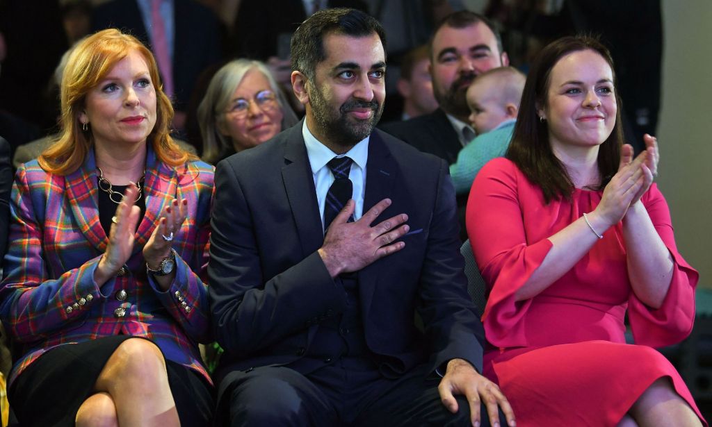 Scottish National Party (SNP) leadership candidates Ash Regan (L) and Kate Forbes (R) applaud as Humza Yousaf (C) wins the SNP Leadership election vote