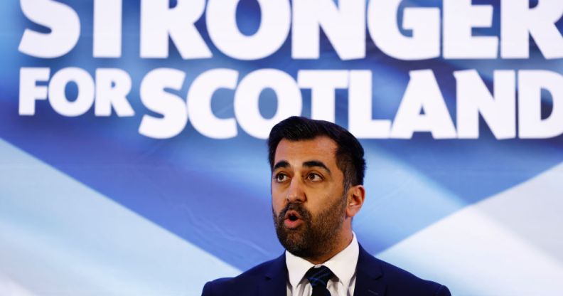 Humza Yousaf in font of a Stronger for Scotland sign