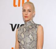 Actor Jena Malone wears a black, white and grey snake skin patterned outfit as she poses for the camera
