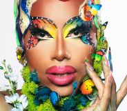 Texas-based drag queen Kylee Ohara Fatale poses for the camera while wears rainbow butter-fly themed makeup with butterfly props and flora in her makeup