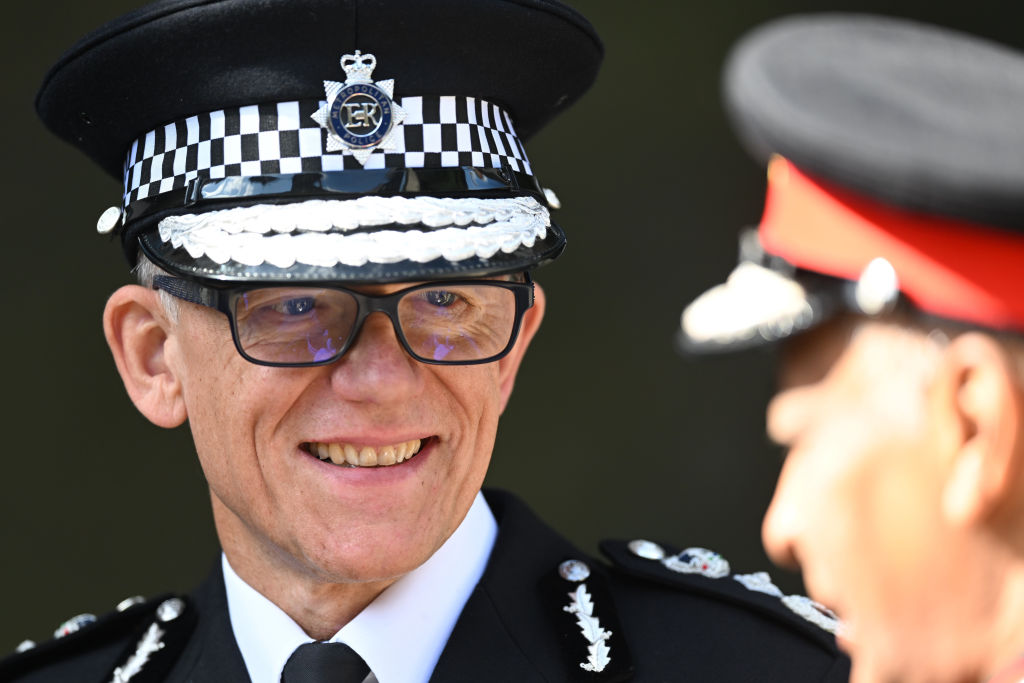 Metropolitan Police Commissioner Mark Rowley smiles during a visit from Britain's King Charles III.