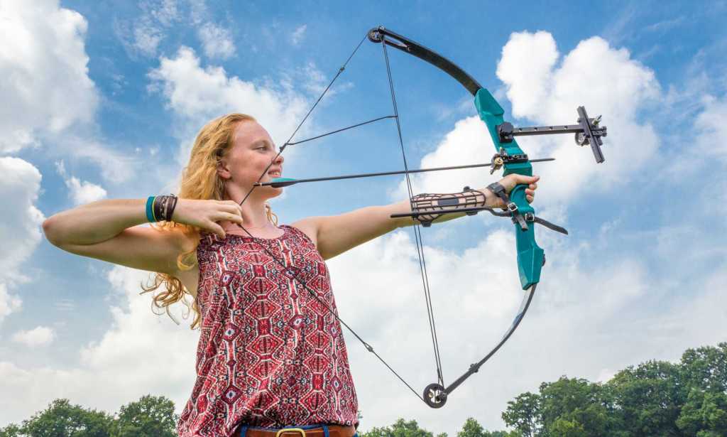 A young girl holding a bow and arrow