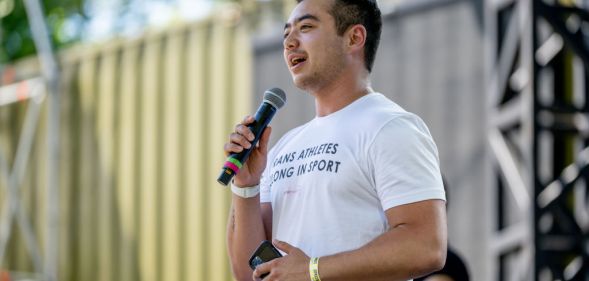 Schuyler wearing a shirt that says trans athletes belong in sport