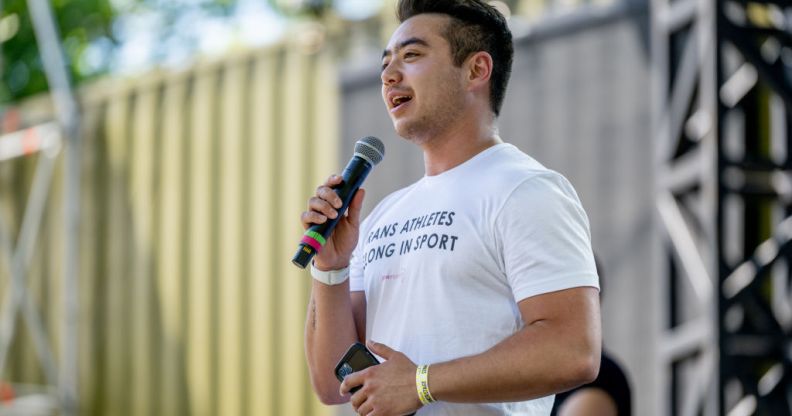 Schuyler wearing a shirt that says trans athletes belong in sport