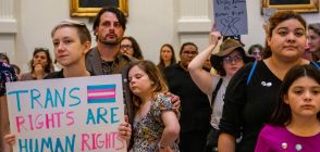 A person holds up a sign reading "trans rights are human rights" during a protest as lawmakers across the US including Texas and Tennessee file bills attacking LGBTQ+ rights
