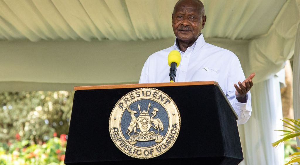 Uganda's president Yoweri Museveni standing at a lecturn
