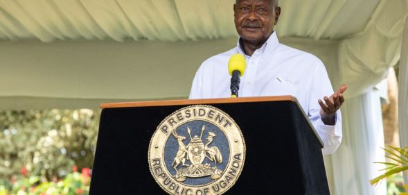 Uganda's president Yoweri Museveni standing at a lecturn