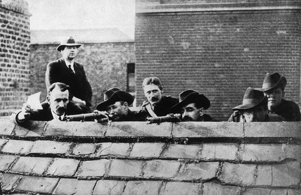 Some Irish rebels lying in wait on a roof getting ready to fire during the Easter Rising.