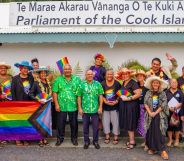 Members of Pride Cook Islands and parliament members celebrate outside Cook Islands parliament.