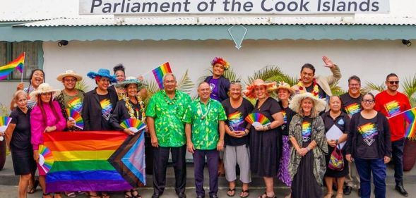 Members of Pride Cook Islands and parliament members celebrate outside Cook Islands parliament.