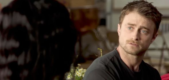 Daniel Radcliffe turning his head to look at an unidentified person.