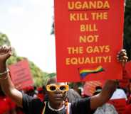 DeLovie Kwagala pictured holding a sign that says "Uganda Kill the bill not the gays equality!".