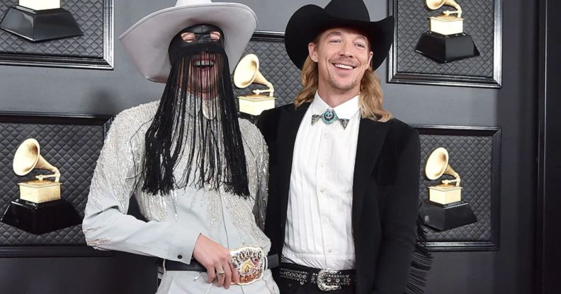 Orville Peck and Diplo laughing at the Grammys 2020