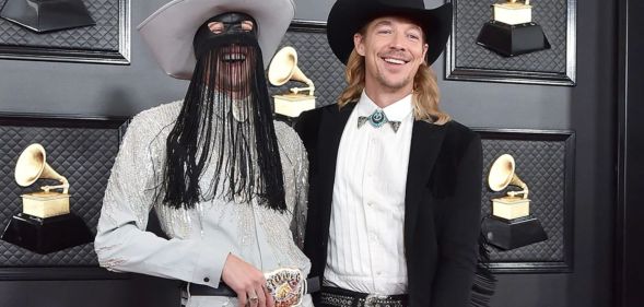 Orville Peck and Diplo laughing at the Grammys 2020