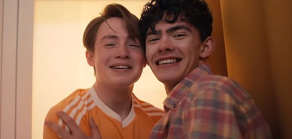 Kit Connor as Nick nelson (left) and Joe Locke as Charlie Spring (right), hugging in a photo booth. Heartstopper will conclude with Volume 6.