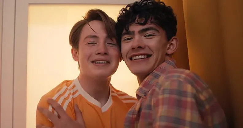 Kit Connor as Nick nelson (left) and Joe Locke as Charlie Spring (right), hugging in a photo booth. Heartstopper will conclude with Volume 6.