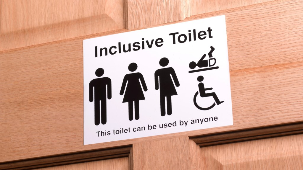 Stock image of an inclusive bathroom sign to illustrate article explaining law in Kansas banning trans people from using the correct bathroom