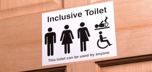 Stock image of an inclusive bathroom sign to illustrate article explaining law in Kansas banning trans people from using the correct bathroom