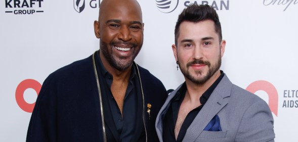 Karamo Brown (L) with partner Carlos Medel (R).