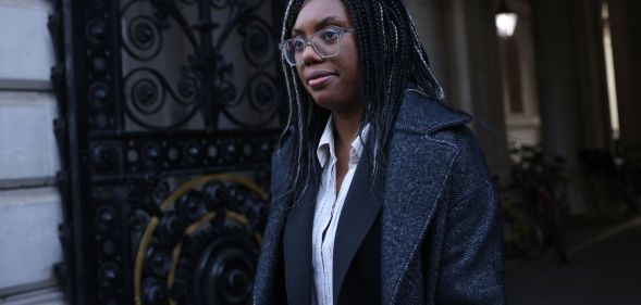 Kemi Badenoch walking down a London street.