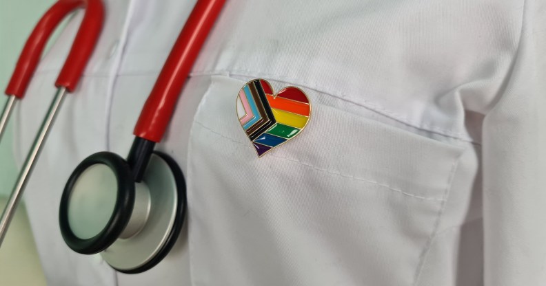 Silhouette of doctor in white coat with stethoscope and LGBT badge on pocket concept
