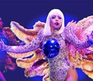 Lady Gaga, wearing a winged costume with a blue ball on her chest, performs onstage during The ARTPOP Ball tour opener