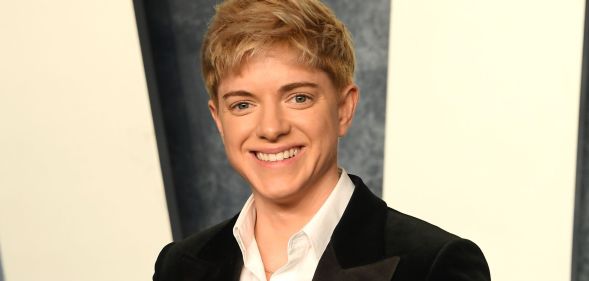 Mae Martin wearing a black suit jacket and white shirt while at the Vanity Fair Oscars afterparty.