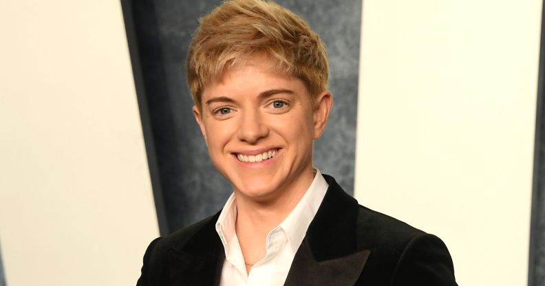 Mae Martin wearing a black suit jacket and white shirt while at the Vanity Fair Oscars afterparty.