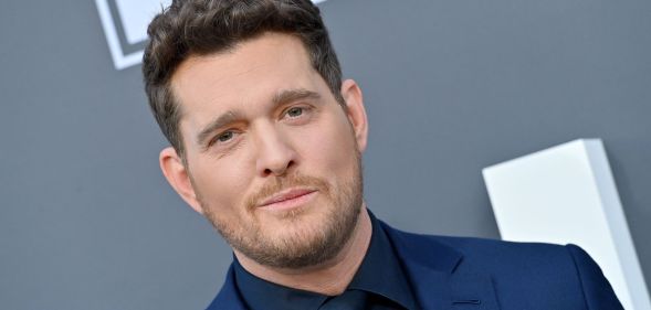 Michael Bublé in a blue suit and black shirt on the red carpet at the 2022 Billboard Music Awards.