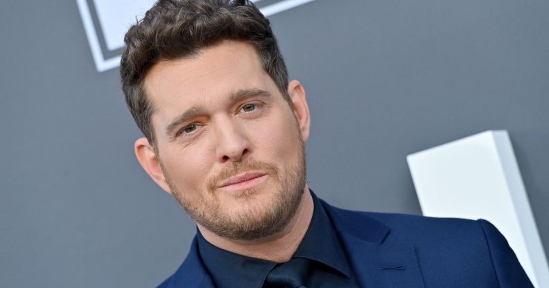 Michael Bublé in a blue suit and black shirt on the red carpet at the 2022 Billboard Music Awards.