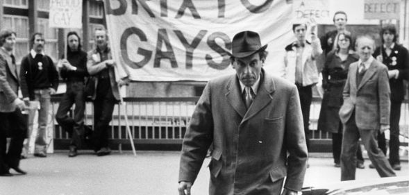 Jeremy Thorpe pictured outside the Old Bailey with the Brixton Gays demonstrating in the background.