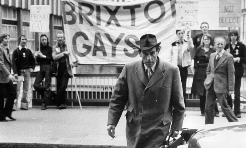 Jeremy Thorpe pictured outside the Old Bailey with the Brixton Gays demonstrating in the background.