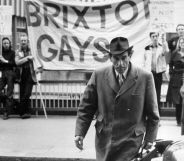 Jeremy Thorpe pictured outside the Old Bailey with the Brixton Gays demonstrating in the background.